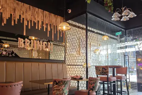 The dining room at Fress, marble tables and tiled walls